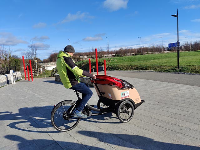 A volunteer pilot on a Cycling Without Age Trishaw in Dodder Valley Park